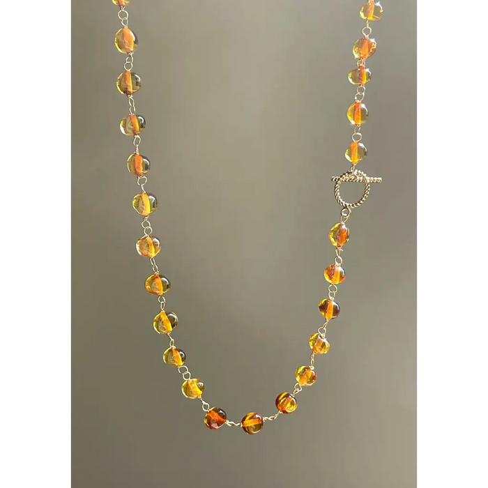 Lot 487 - Old amber necklace with a string of
